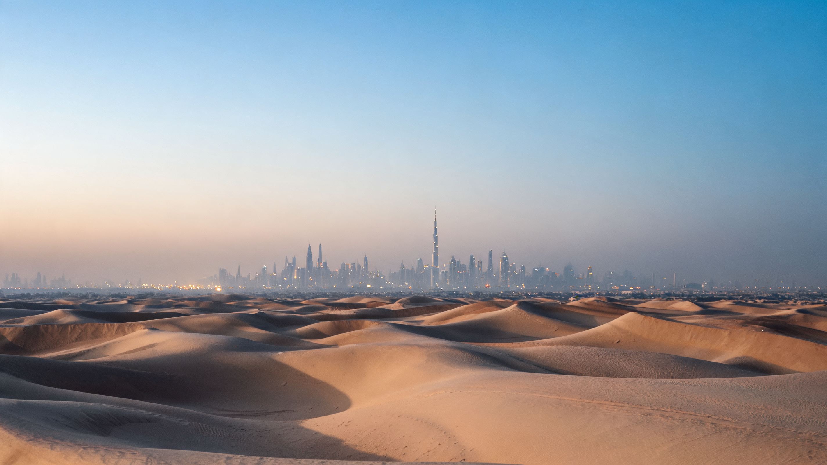 Dubai skyline beyond sculpted desert dunes